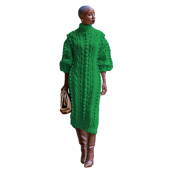 Person wearing a green cable knit dress on a white background