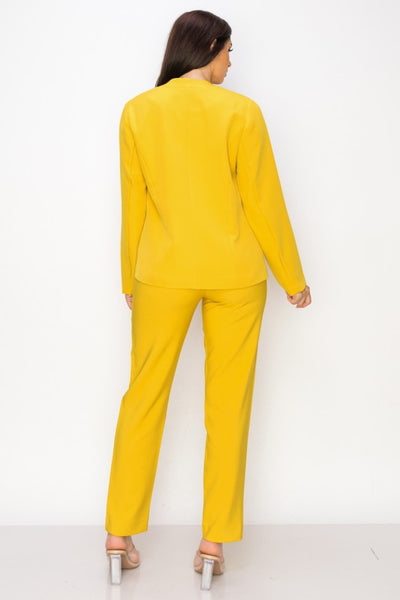 Woman wearing a yellow suit against a white background