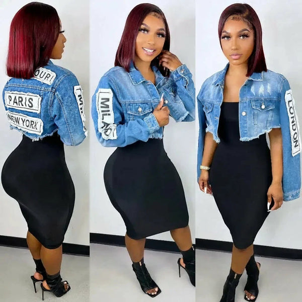 SlayEdgeBoutique cropped denim jacket with distressed finish and letter print sleeves worn over a black midi dress
