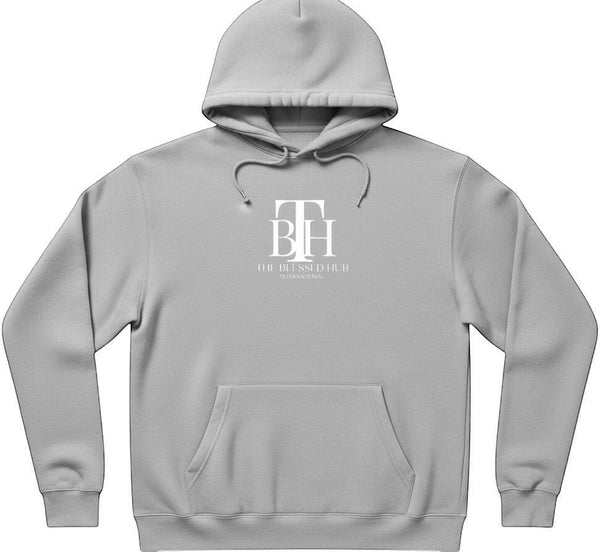 SlayEdgeBoutique grey pullover hoodie with The Blessed Hub International logo, drawstring hood, and front pocket.