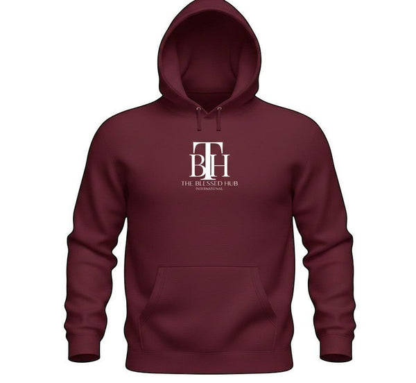 SlayEdgeBoutique maroon pullover hoodie with white The Blessed Hub International logo, drawstring hood and pocket.