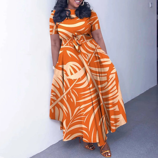 SlayEdgeBoutique orange and cream leaf print short sleeve maxi dress with an asymmetrical hem and waist tie.