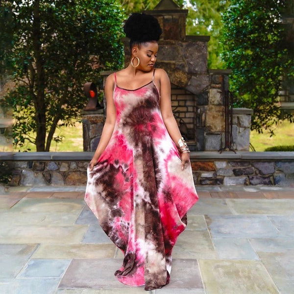 SlayEdgeBoutique sleeveless maxi dress in a vibrant pink and brown tie-dye print with spaghetti straps on a woman.