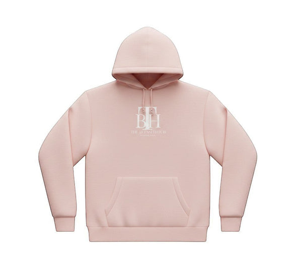 SlayEdgeBoutique light pink pullover hoodie with The Blessed Hub International logo and kangaroo pocket