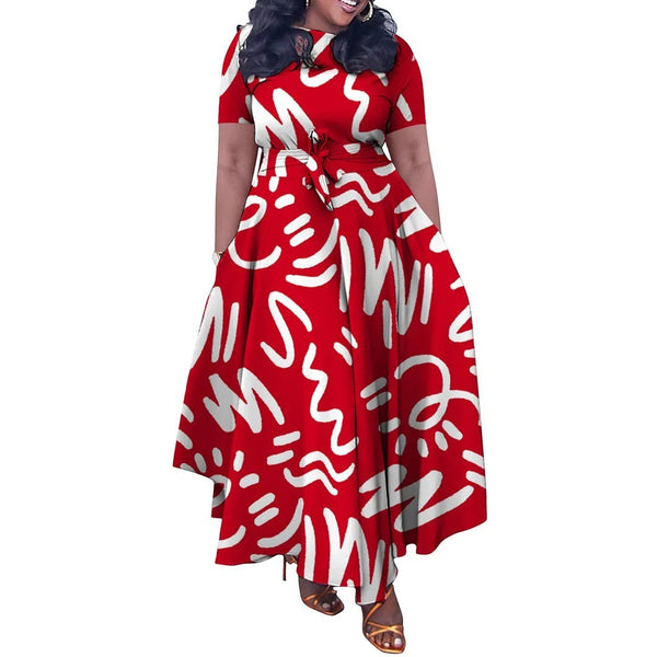 SlayEdgeBoutique red and white abstract print short sleeve maxi dress with an asymmetrical hem and waist tie.
