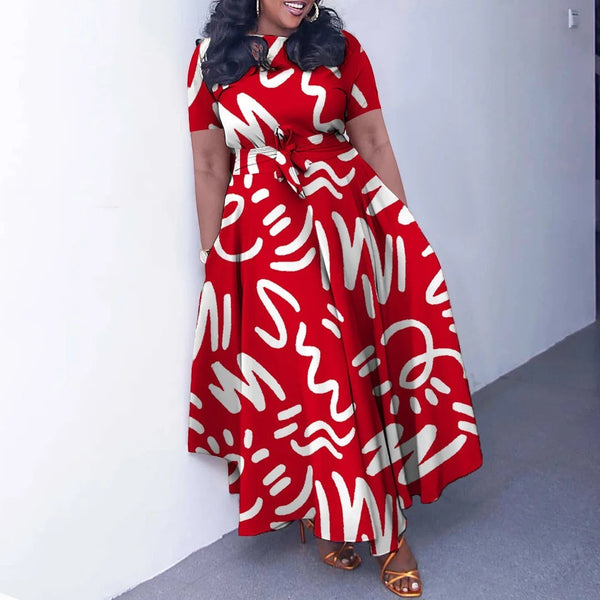SlayEdgeBoutique red and white abstract print short sleeve maxi dress with an asymmetrical hem and waist tie.