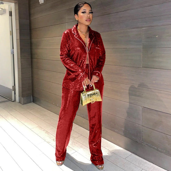 SlayEdgeBoutique red sequin blazer and trouser matching set worn by a woman with a gold handbag