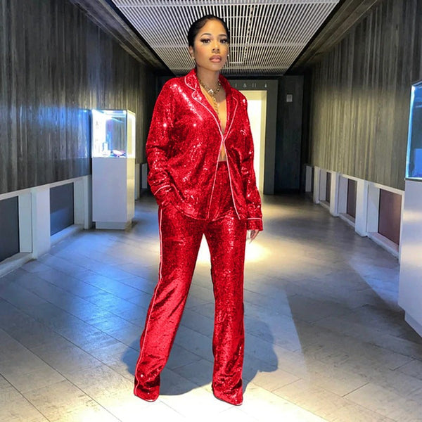 SlayEdgeBoutique red sequin blazer and trouser matching set worn by a model in a modern hallway.