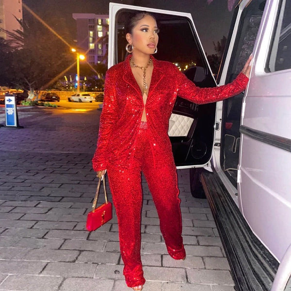 SlayEdgeBoutique red sequin blazer and trouser matching set worn by a woman stepping out of a car at night