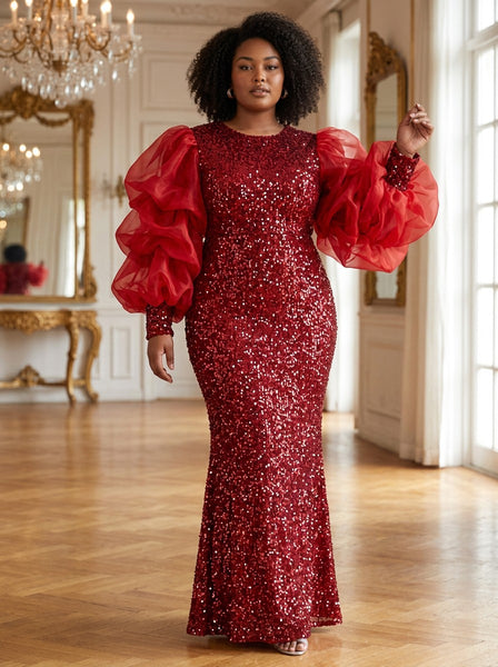 A model wearing a SlayEdgeBoutique red sequin floor-length evening gown with dramatic organza puff sleeves.